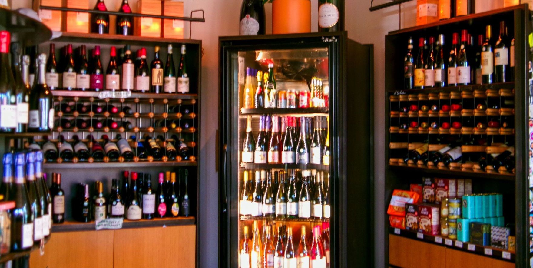 Vibrant wine shop interior showcasing assorted wine bottles on shelves.